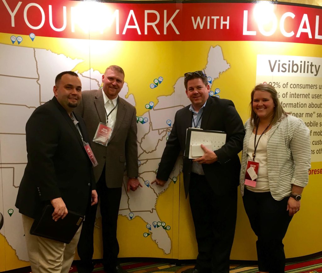 Members of Team ETG place a location pin on the UniGroup Map at the 2016 Learning Conference in St. Louis, MO